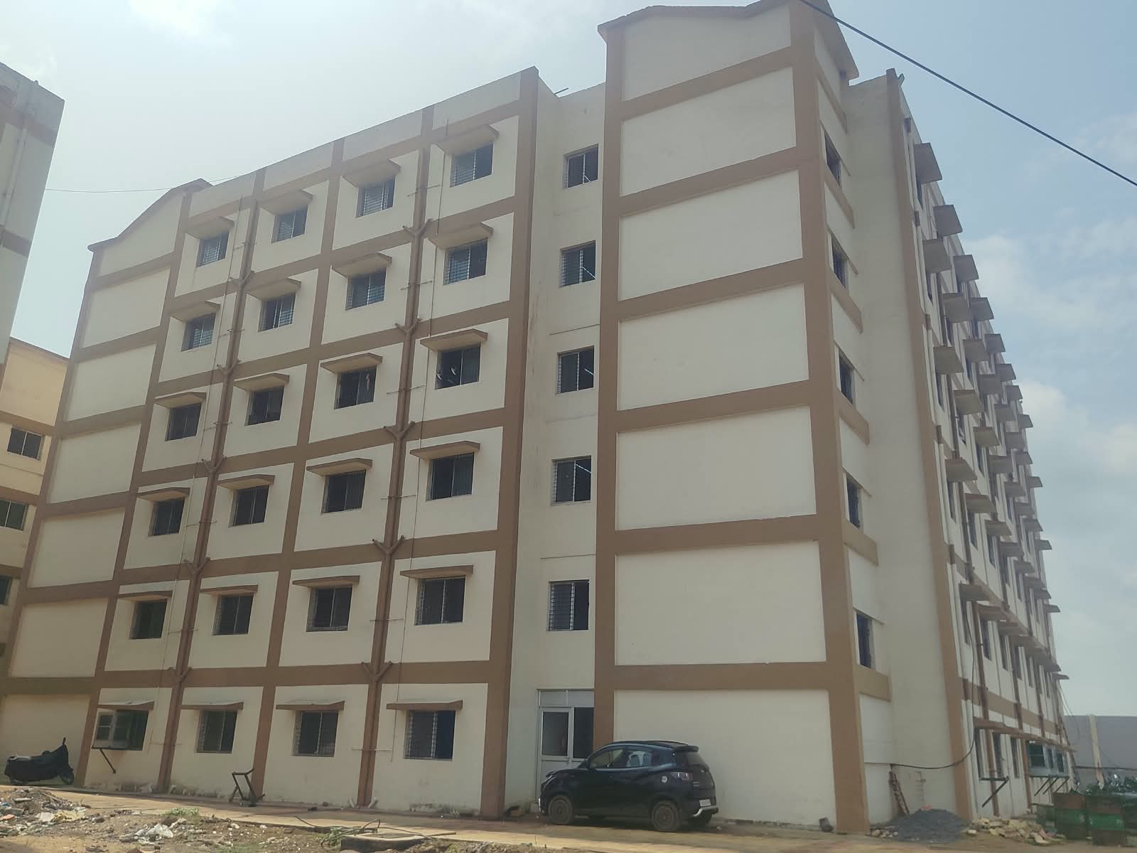 Side view of a completed Real Colony residential block at GK TMT, Bhatapara